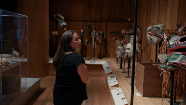 U’mista Cultural Centre’s Executive Director Juanita Johnston (Weḵa'yi / Haida) in the Potlatch Gallery at U’mista Cultural Centre in Alert Bay, BC.